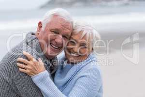 Senior couple standing together on the beach