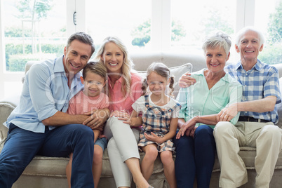 Multi generation family sitting on sofa in living room