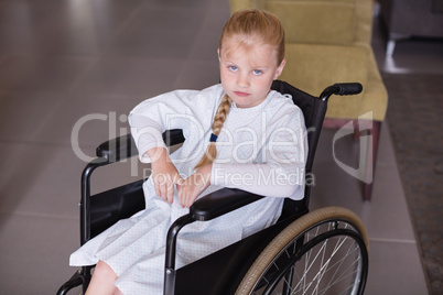 Portrait of sad girl patient sitting on a wheelchair