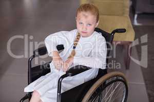Portrait of sad girl patient sitting on a wheelchair
