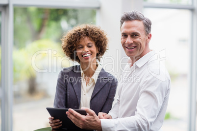 Business executives holding digital tablet