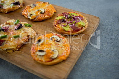 Various pizza arranged on a wooden tray