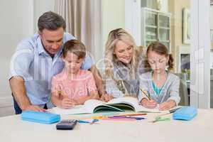 Parents assisting children doing homework