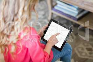Girl using digital tablet in living room