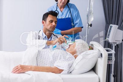 Doctor putting an oxygen mask on patient