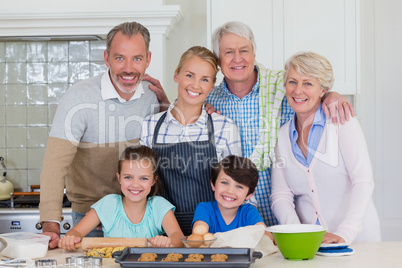 Portrait of happy multi-generation family standing in kitchen