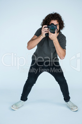 Photographer with digital camera in studio