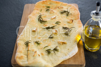 Italian pizza with olive oil on a chopping board