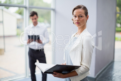 Businesswoman holding a file at conference centre