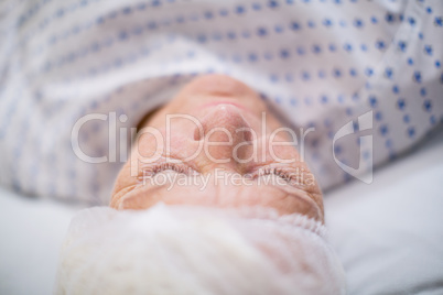 Senior woman patient sleeping on bed