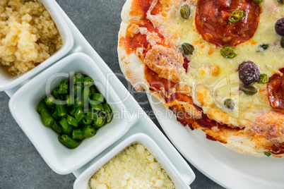 Italian pizza served on a plate with various ingredients