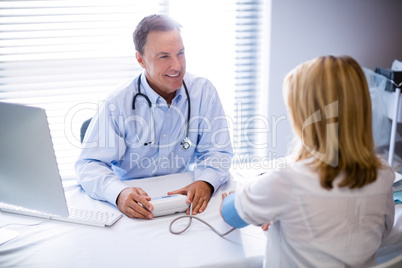 Doctor checking blood pressure of a patient