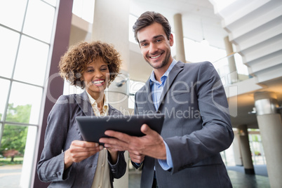 Business executives discussing over digital tablet