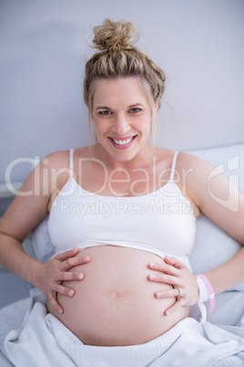 Portrait pregnant woman relaxing on hospital bed