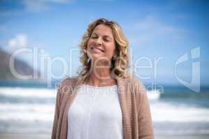 Mature woman standing on the beach