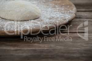 Pizza dough and flour on rolling board