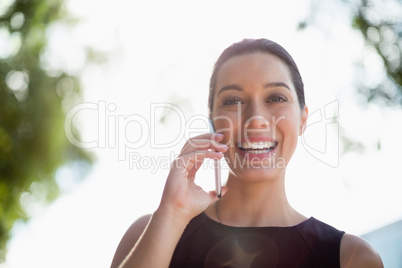 Happy businesswoman talking on mobile phone