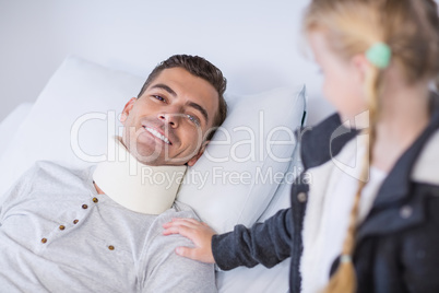 Smiling daughter comforting her sick father