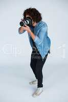Photographer with digital camera in studio