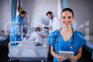 Portrait of smiling female doctor holding digital tablet