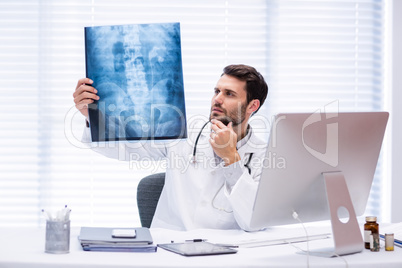Male doctor examining x-ray