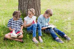 Kids reading books in park