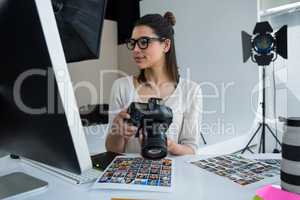 Female photographer reviewing captured photos in her digital camera