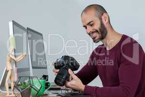 Photographer reviewing captured photos in his dslr camera