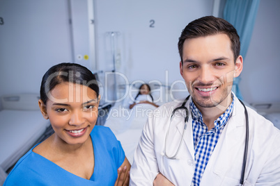 Portrait of smiling doctor and nurse standing together