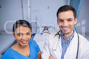 Portrait of smiling doctor and nurse standing together