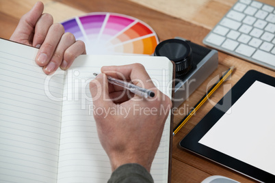 Close-up of photographer working at desk