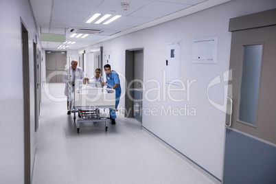 Portrait of smiling female and male doctor standing together in passageway
