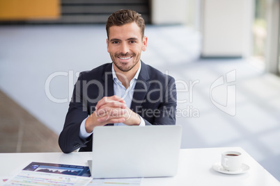 Businessman sitting with laptop