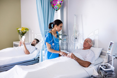 Female doctor interacting with male senior patient