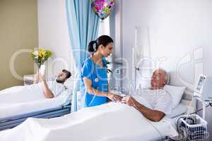 Female doctor interacting with male senior patient