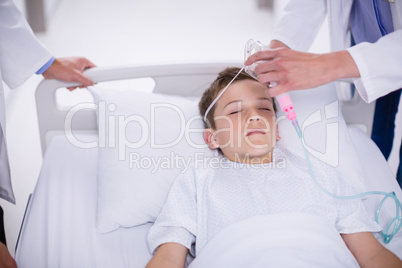 Doctor putting an oxygen mask on patient