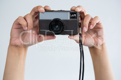 Close-up of female photographer holding old fashioned camera