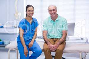 Portrait of smiling doctor and senior patient