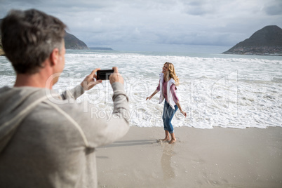 Mature man clicking a picture of woman