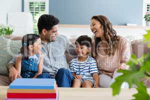 Parents and kids interacting on sofa in living room