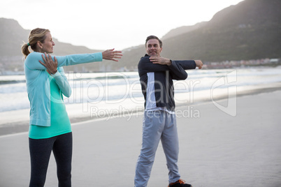 Mature couple doing stretching exercise