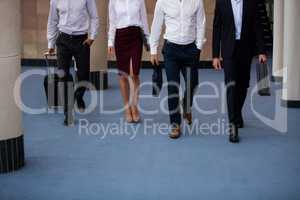 Business executives walking in a conference center lobby