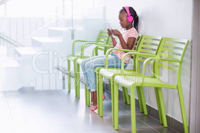 Girl listening to music from digital tablet