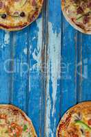 Various italian pizza served on wooden plank