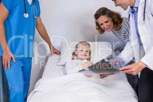 Doctors showing x-ray to patient and mother