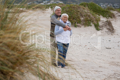 Senior couple standing together on the beach