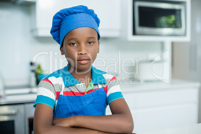 Portrait of boy in chefs hat at home