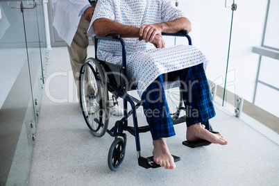Doctor carrying a patient on a wheelchair