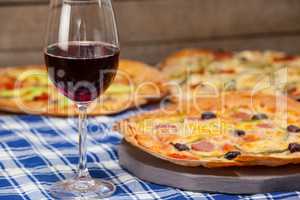 Delicious pizza with a glass of red wine