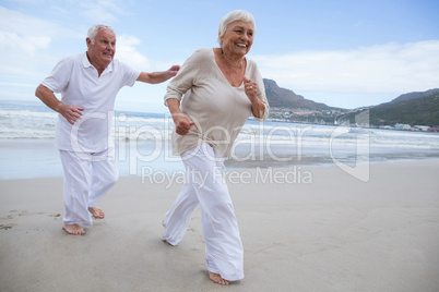 Senior couple having fun together at beach